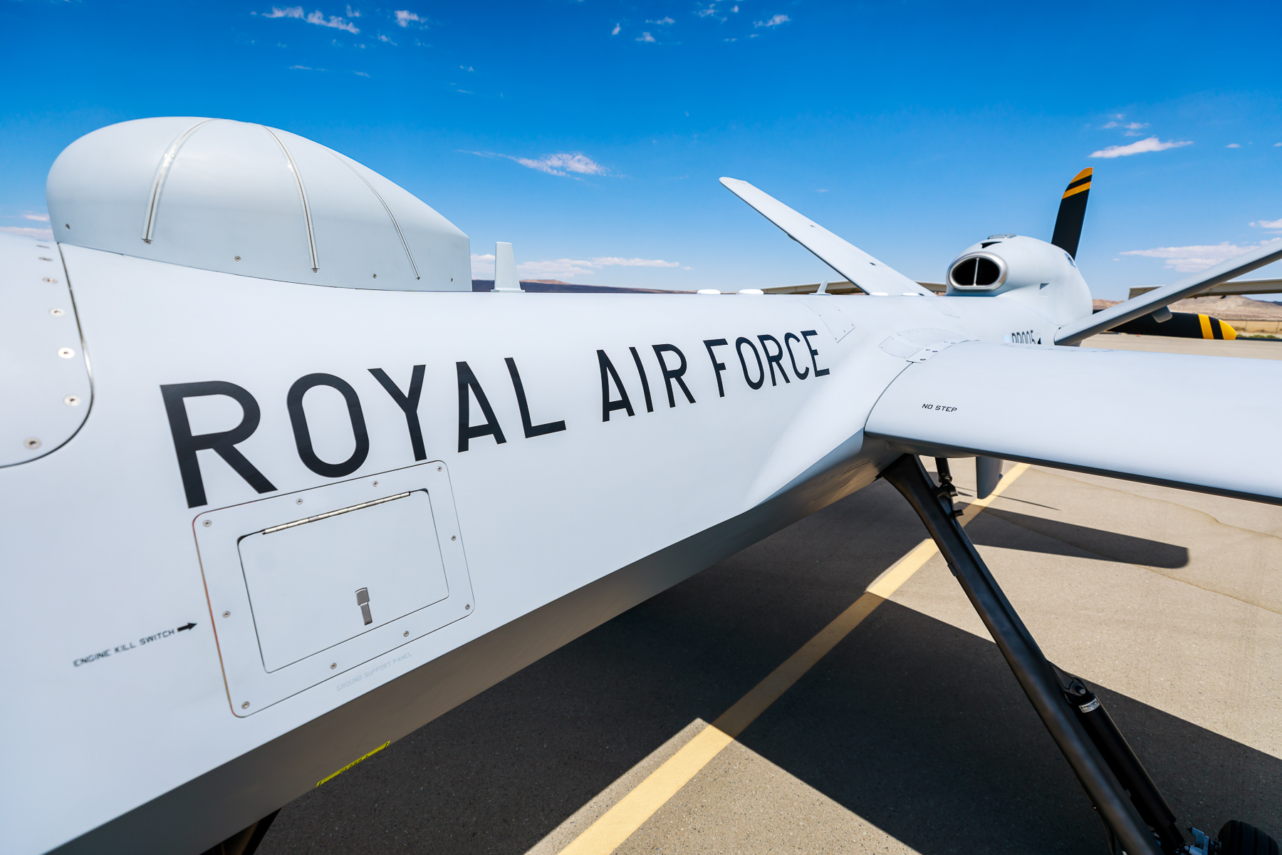 Image shows the words Royal Air Force up close on the side of an RAF Protector aircraft while on the ground.
